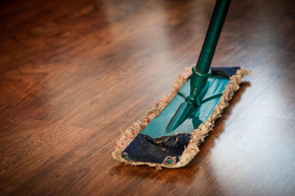 A mop gliding over a polished wooden floor