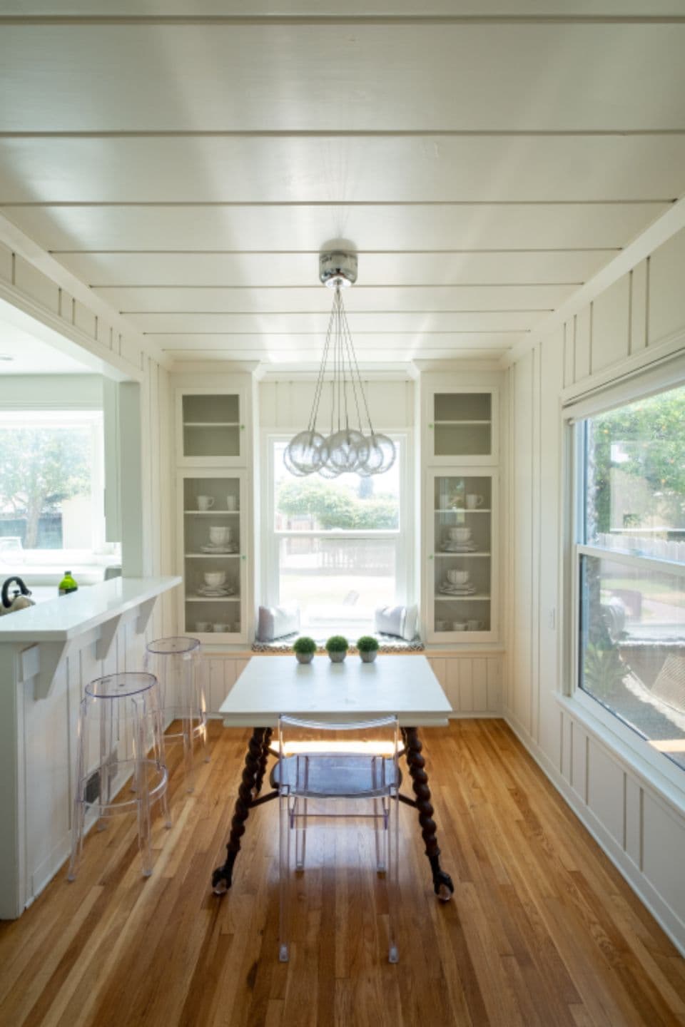A bright kitchen and dining area with wooden floors