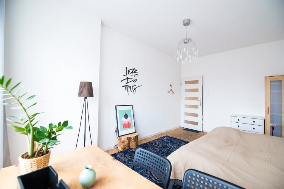 A bright, open loft with a bed and a workspace